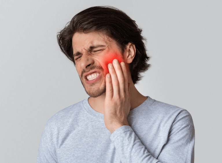 Man in tooth pain before visiting emergency dental care at Harwood dental practice in bolton