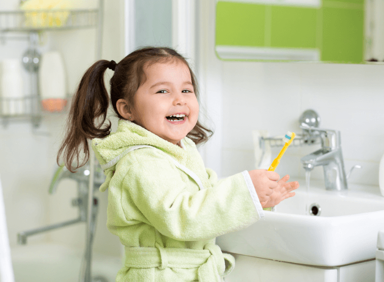 Little girl brushing her teeth after visit at bolton dentist at Harwood dental practice